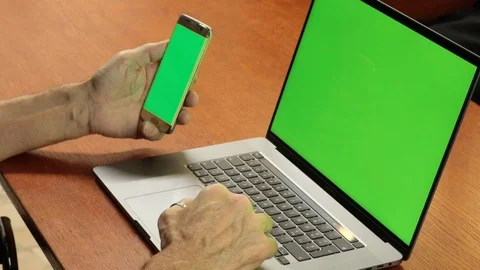 Side view of man with smartphone and computer. fingers touching the touchpad Stock Footage 127458621