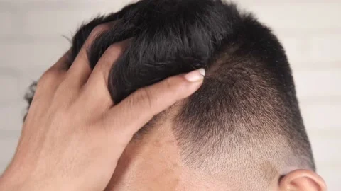 Side view of man styling hair on white background, Stock Footage 149485317