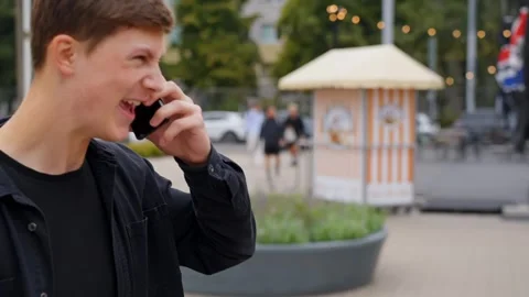Side view of man talks on phone aggressively outdoors Stock Footage 336800119