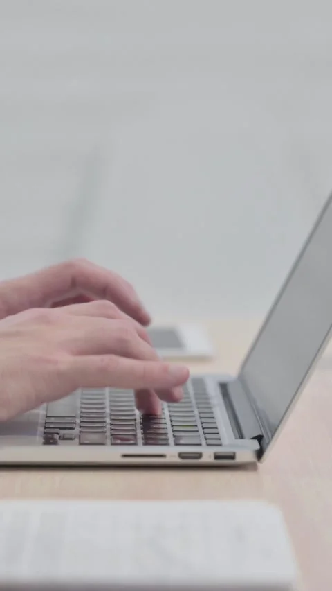 Side View of Man Typing on Laptop, vertical video 動画素材 329105174