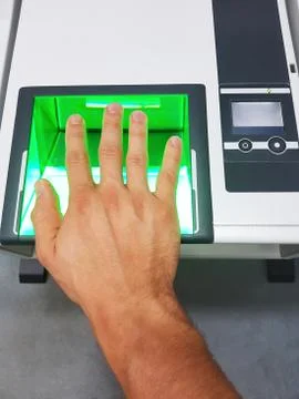 Side view from a man using a fingerprint scanner for identification. Biometrics Stock-Fotos