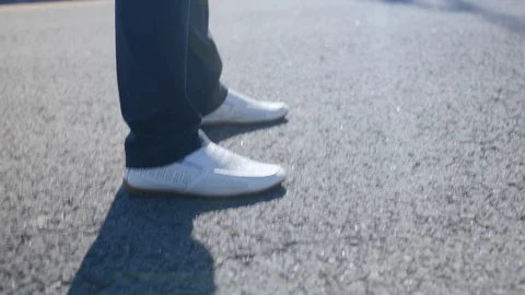 Side view of a man walking along the road. Close up shot. Stock Footage 114133708