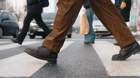 Side view of man walking city street crosswalk on winter day. Male feet steps Stock Footage 326826221