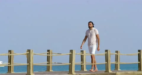 Side view of a man walking on a water bridge Stock-Footage 209944881