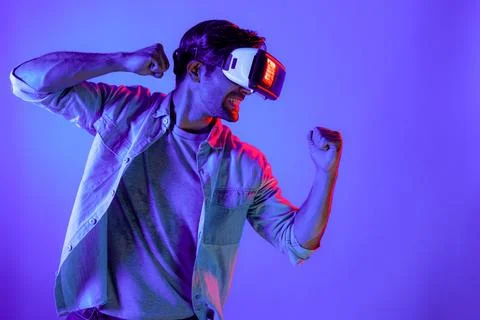 Side view of man wearing VR glass and smashing or punching at camera. Deviation. Stock Photos