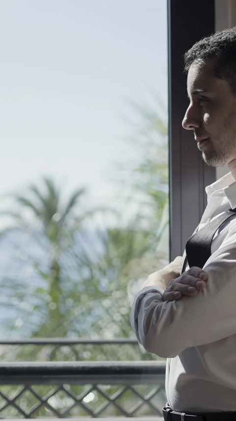 Side view of a man in white suit standin... | Stock Video | Pond5