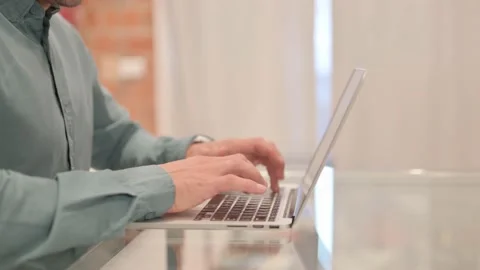 Side View of Man Working on Laptop Video stock 238646047