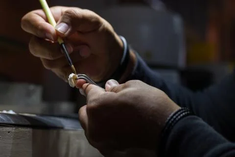 Side view of a man working the prosthetic tooth. Stock Photos