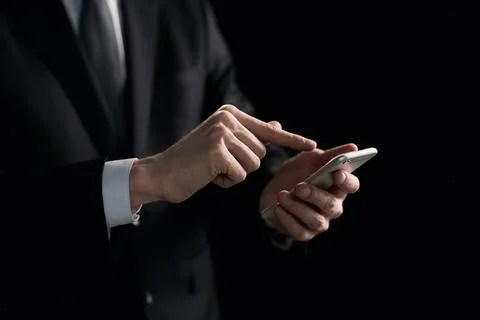 Side view of a man's hand presses a finger on a smartphone. Mock up for your Stock Photos