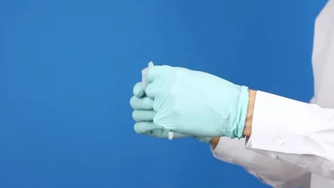 Side view on man's hands in surgery gloves, show medical mask and puts it Video stock 126998931