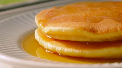 Side View of Maple Syrup Soaked Soft Buttermilk Pancakes Plated and Ready to Stock Footage 338403356