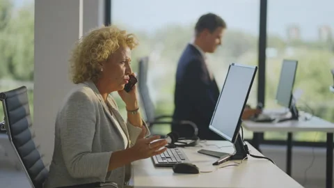 Side view on mature woman solving problem by cell phone. Searching data in Stock Footage 164410480