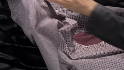 Side view-merchandiser buttoning a luxury businessman burgundy dress shirt 4k Stock Footage 96291565