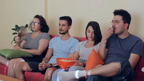 A side view of a mid shot on group of young people watching TV Stock-Footage 93873300
