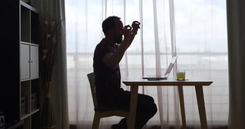 Side view of middle-aged bearded man dancing while sitting in front of laptop Stock Footage 160401200