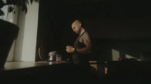 Side view of a millennial authentic caucasian man standing in the kitchen, relax 스톡 동영상 252248919