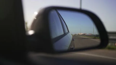 Side view mirror of the car in motion. Track at sunset, nature from the car Video stock 194561180