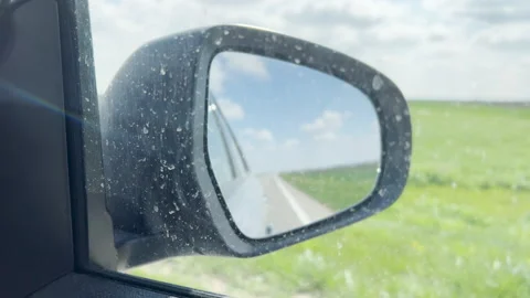 Side view mirror of a car seen through dirty window Video stock 220652463