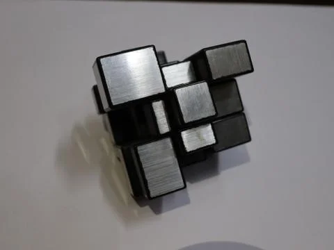 Side view of the mirror cube puzzle kept on the table. Stock Photos