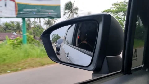 Side View Mirror Reflecting Nature and Road During a Scenic Drive Stock Footage 305367615