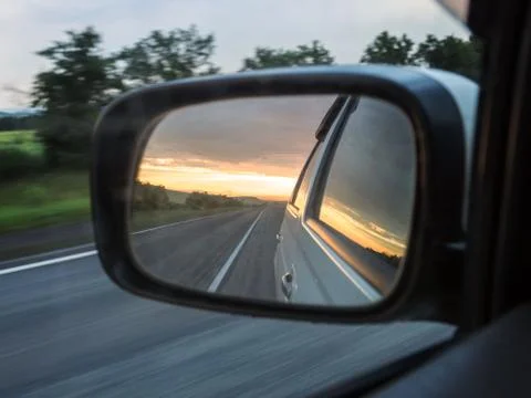 Side view mirror reflection of the two-lane winding road. 写真素材