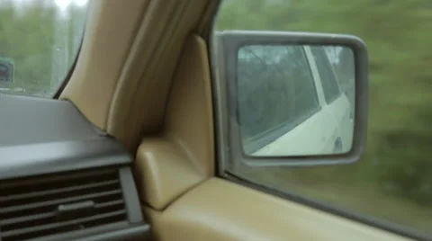 Side-view mirror in a vintage car. Driving along the road, taking turn. Stock Footage 68026023