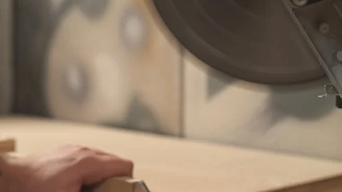 A side view of a miter saw cutting a work piece at a selected angle. Stock Footage 103365959