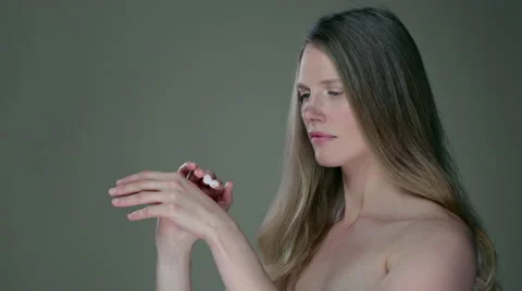Side on view of model appyling cream to hands. Stock Footage 63030323
