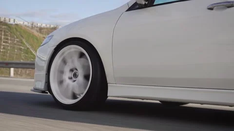 Side view of modern powerful white car rides on summer highway. Footage. Perfect Stock Footage 144367937