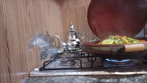 Side View of Moroccan Tagine Cooking on Gas Stove Flame Stock Footage 333682555