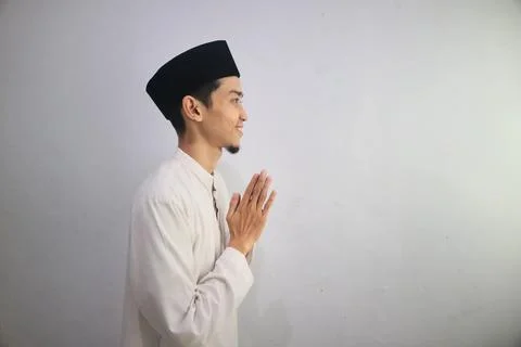 Side view of Moslem Asian man smiling while greet someone during Ramadan ce.. Stock Photos