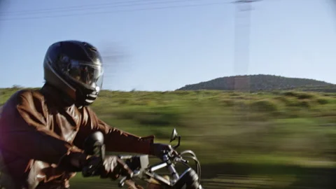 Side view of a motorcyclist on the road Stock Footage 279268559