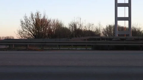 Side view of motorway traffic in warm sunrise light Stock Footage 331187662