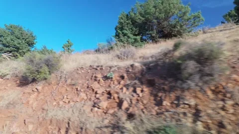 Side view from a moving car driving past rural landscapes and hills Stock Footage 342330627