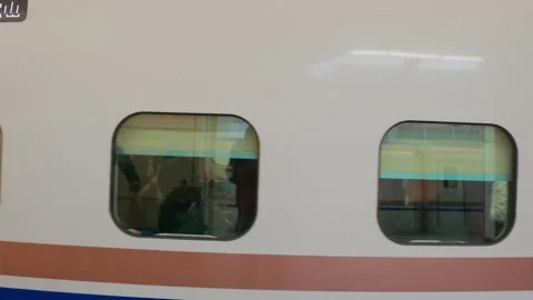 Side view of a moving Japanese high-speed bullet train with passengers Vídeos de archivo 332162735