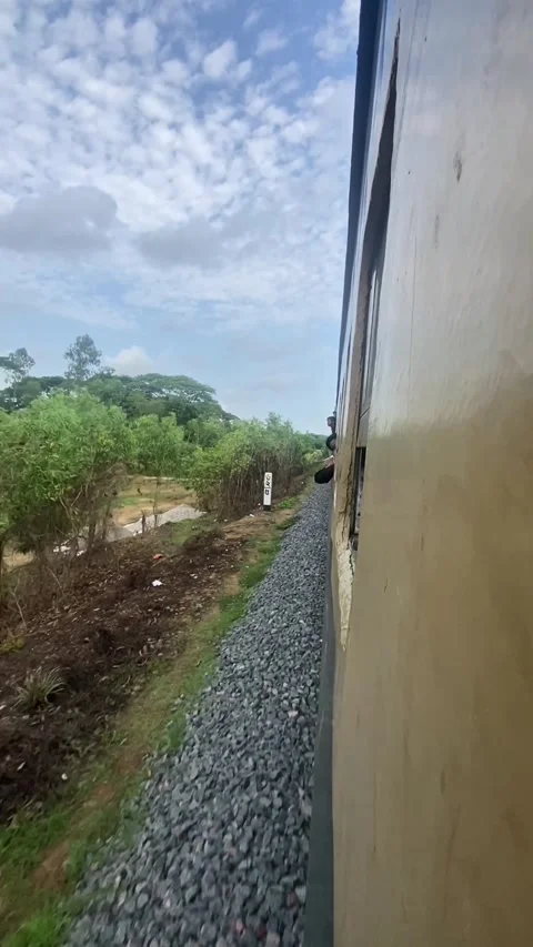 Side view of moving passenger train running through green rural landscape Stock Footage 340140563