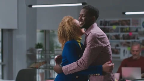Side view of multiethnic colleagues hug and greet each other meeting in office Stock Footage 189227899