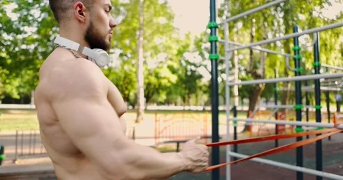 Side view of muscular bearded man building arm and back muscles training with Stock Footage 157562727