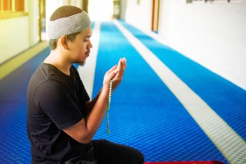 Side view of muslim man making du'a Stock Photos