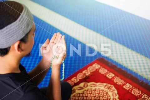 Side view of muslim man making du'a Stock Photos