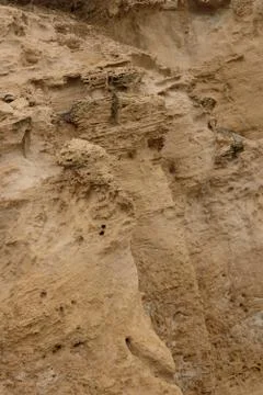 Side view of the natural background of yellow limestone with the bumpy surfac Stock Photos