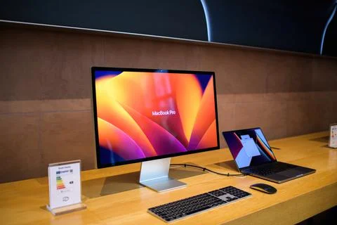 Side view of new Apple Computers MacBook Pro connected to the Studio Display 5k Stock Photos