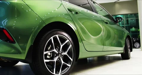 Side view of a new car close-up dolly shot. A new car is sold at a car showroom. Stock Footage 304090601