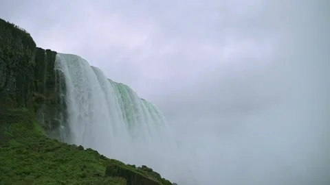 Side view of Niagara Falls with water powerfully cascading over cliffs Stock Footage 291985559