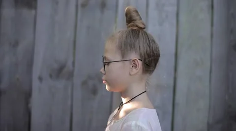 Side View: Nice Girl With a Bump Meditates on a Background of Wooden Fence Stock Footage 66288885