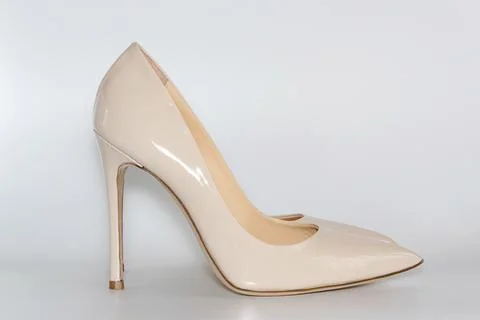 Side view of nude beige colored high heeled women's shoes. Stock Photos