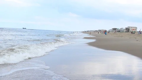 Side View Ocean Waves &amp; Anonymous Tourists Stock Footage 106674058