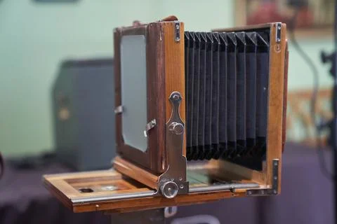 Side view of the old camera on the background of the table. An old camera in an Stock Photos