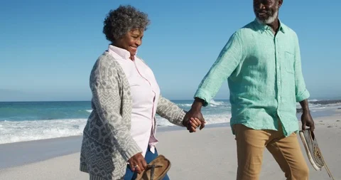 Side view old couple walking at the beach Stock Footage 125719421