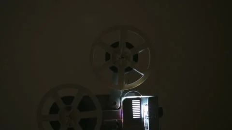 Side view of an old-fashioned antique film projector. Includes projector audio Stock Footage 60698100